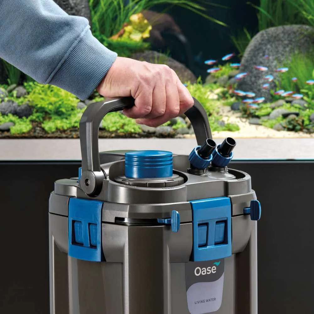 OASE BioMaster2 Thermo 600 løftes ved akvariet